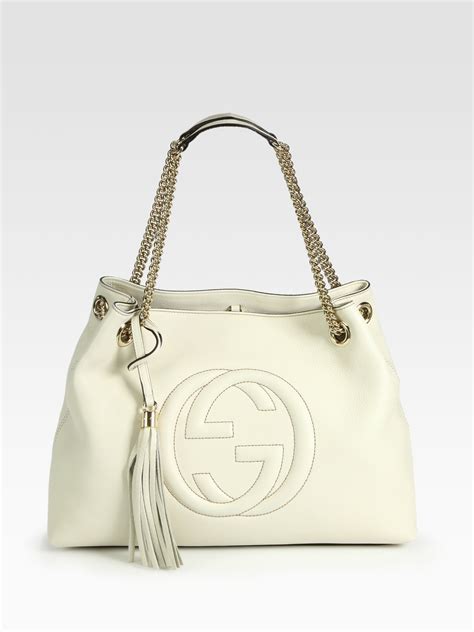 gucci bluzki|white Gucci handbag.